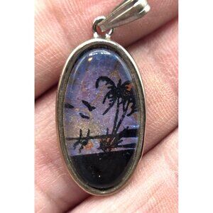 Oval Silver Tone Pendant With Tropical Palm Tree & Sunset Scene Blue & Black Col